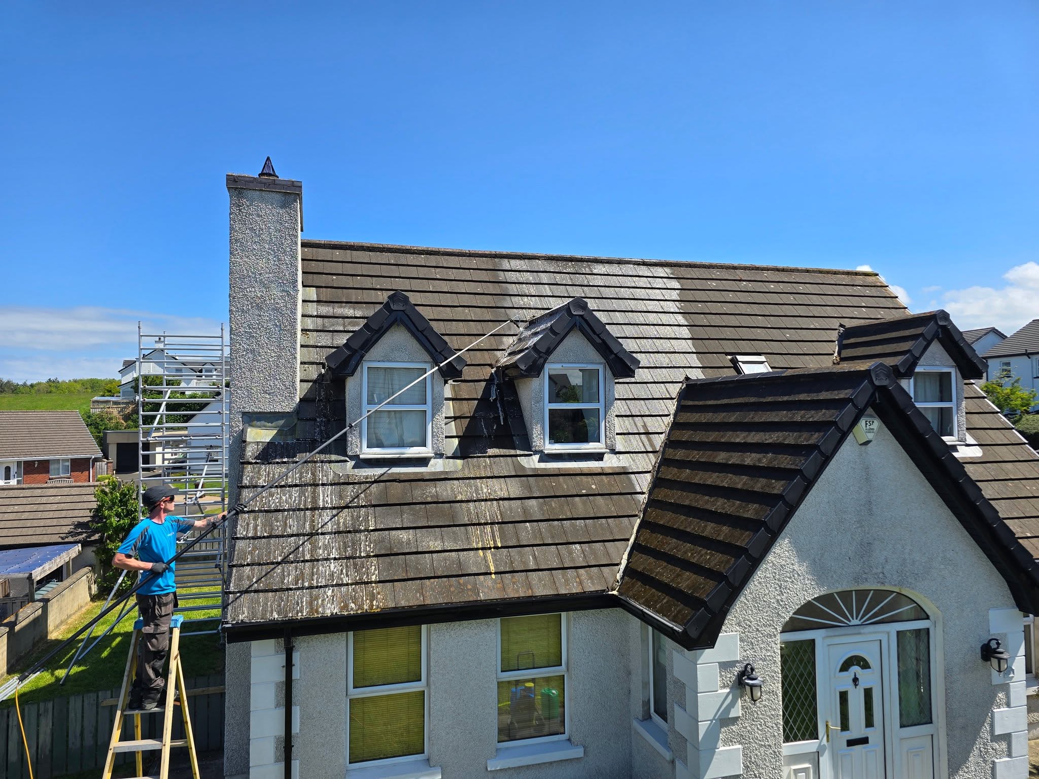 Professional roof cleaning in progress on a residential home in Northern Ireland